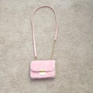 A pink fluffy purse